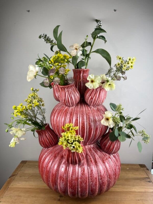 Composition florale dans un vase sculptural en céramique rouge